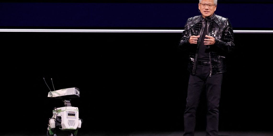 Nvidia CEO Jensen Huang with a robot at the show. Pic: Reuters