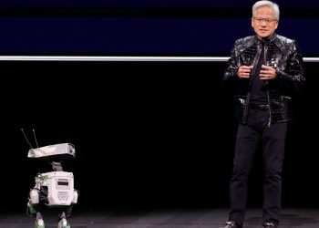 Nvidia CEO Jensen Huang with a robot at the show. Pic: Reuters