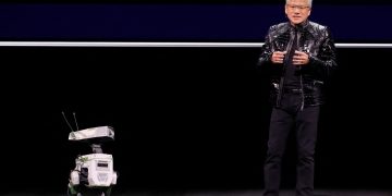 Nvidia CEO Jensen Huang with a robot at the show. Pic: Reuters