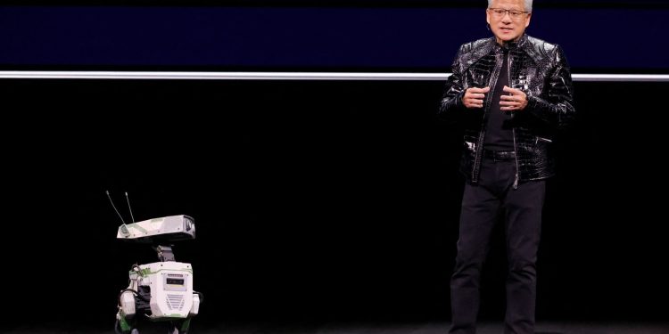 Nvidia CEO Jensen Huang with a robot at the show. Pic: Reuters
